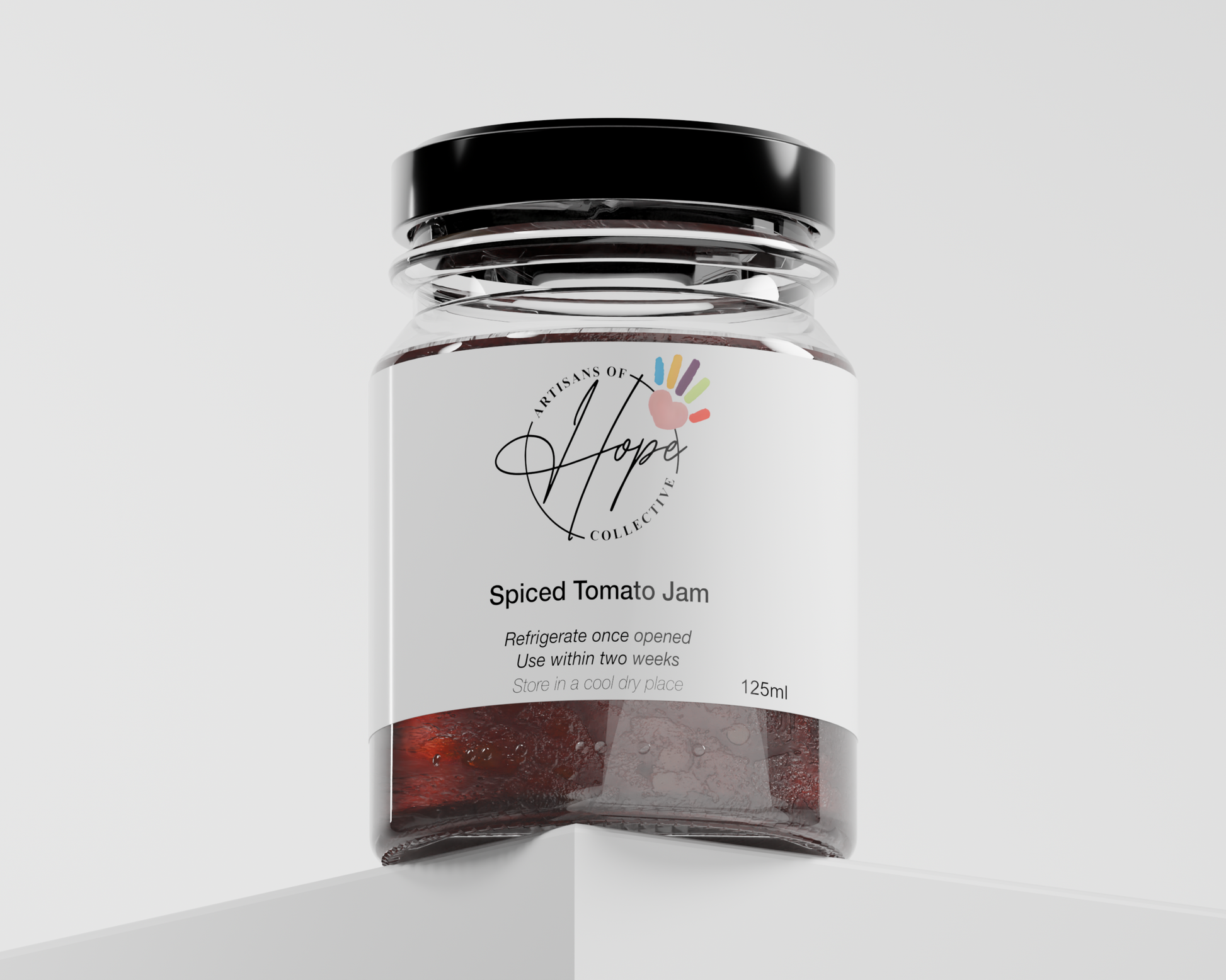 Jar of Spiced Tomato Jam with 'Artisans of Hope' label on a white background