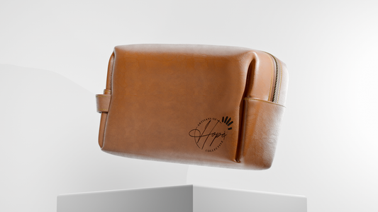 Brown leather toiletry bag with a brand logo on a white background