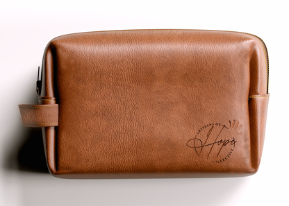 Brown leather toiletry bag with a brand logo on a white background